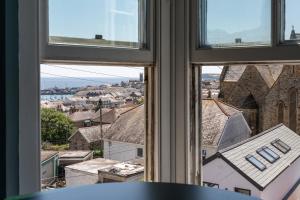 a view of a city from a window at Modern Studio Apartment with harbour views in Penzance +5 photos