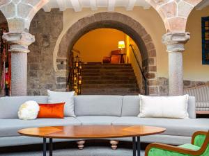 a living room with a couch and a table at Novotel Cusco in Cusco
