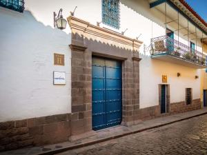 a building with blue doors on a street at Novotel Cusco in Cusco +161 photos