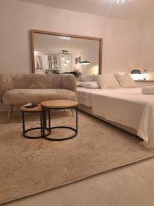 a living room with two beds and a coffee table at Luni Studio Apartment with garden in Kaštela