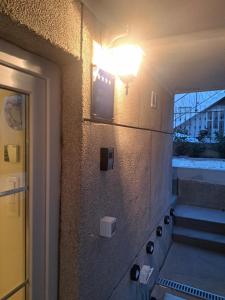 a light on a wall next to some stairs at Luni Studio Apartment with garden in Kaštela +12 photos