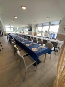 a large dining room with long tables and chairs at Hotel Chiquín in Tapia de Casariego