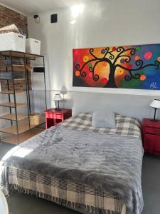 a bedroom with a bed and a painting on the wall at Apartamento El Rancho in San Pedro +8 photos
