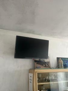 a flat screen tv on top of a shelf at El quincho in San Pedro