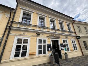 a large yellow building with a sign in front of it at U Císaře Rudolfa in Mělník