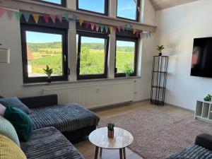 a living room with a couch and a table at Ferienapartment Naturblick in Hausen