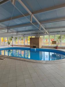 a large swimming pool in a building at Retro Lido - Vonyarcvashegy in Vonyarcvashegy