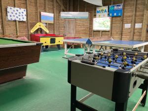a room with ping pong tables and pool tables at Kingfisher Glamping Cabin in Bodmin
