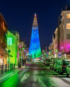 a large building with a clock tower at night at 105 Guesthouse Hotel in Reykjavík