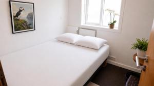 a bedroom with a bed with two pillows on it at 105 Guesthouse Hotel in Reykjavík