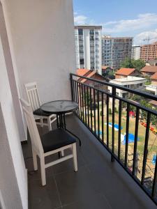 a balcony with a table and chairs and a view at Unik Apartment in Kosovo Polje