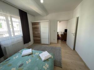 a bedroom with a bed with two pillows on it at Unik Apartment in Kosovo Polje