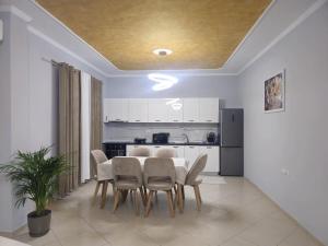 a kitchen and dining room with a table and chairs at Visi garden house in Valjiosi