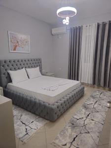 a bedroom with a large bed in a room at Visi garden house in Valjiosi