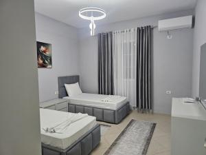 a hospital room with two beds and a window at Visi garden house in Valjiosi +1 photo