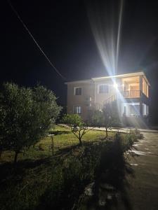 a house at night with the sun shining on it at Visi garden house in Valjiosi