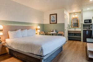 a hotel room with a large bed and a bathroom at Stargazer Hotel in Monterey +65 photos