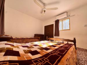 a bedroom with two beds and a ceiling fan at Don Luis Alberto in El Puesto