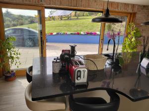 a table with a toaster sitting on top of it at Golf Style in Lisdoonvarna