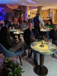 a group of people sitting at tables in a restaurant at Blue Suites Hotel in Bogotá +23 photos