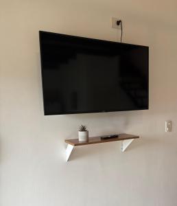a flat screen tv hanging on a wall at Villa Los Cóndores in Las Chacras