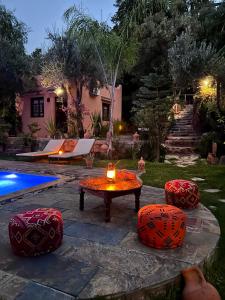 a patio with a table and chairs and a pool at Auberge Le Mouflon in Ouirgane