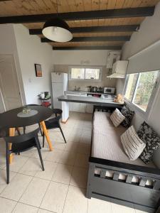 a kitchen and dining room with a table and a couch at Villa Los Cóndores in Las Chacras