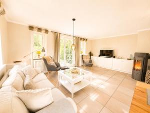 a living room with a white couch and a table at Haus "Carla Marie" in Hedehusum