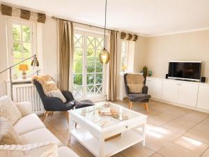 a living room with a white coffee table and chairs at Haus "Carla Marie" in Hedehusum