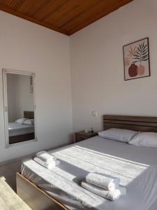 a bedroom with a bed with two towels on it at Maronia Villa in Maronia