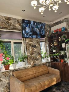 a living room with a couch and some plants at Turg'unTown in Toshkent-Passajir Bekati