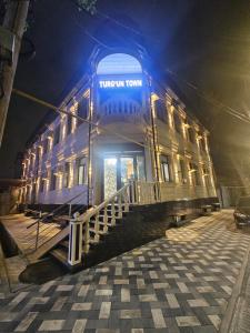 a building with a blue light on top of it at Turg'unTown in Toshkent-Passajir Bekati +1 photo