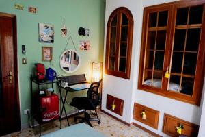 a bedroom with a desk and a chair in a room at Nice room with private bathroom in Ercolano