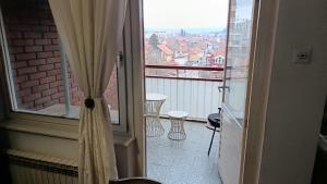 a balcony with a view of a city at City centar apartman in Zaječar +5 photos
