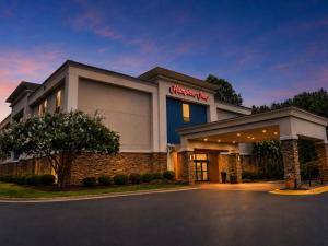 a hotel with a sign on the front of it at Hampton Inn Cartersville in Cartersville