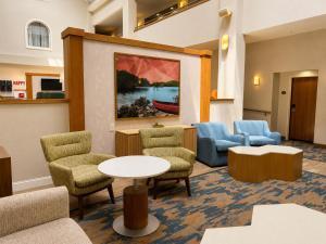 a waiting room with chairs and a table at Hampton Inn Cartersville in Cartersville