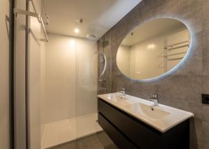 a bathroom with a sink and a mirror at Forest Villa 8 persons #724 in Maasbree +13 photos
