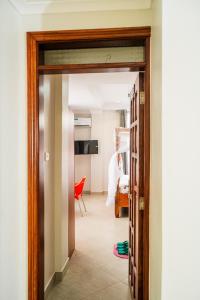 a hallway with a door leading into a room at Kitobo Serenity Resort in Arusha