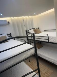a group of bunk beds in a dorm room at Los Alcarrizos Puente Blanco Urban Oasis ubicado en la calle 22 numero 98 los alcarrizos in Santo Domingo