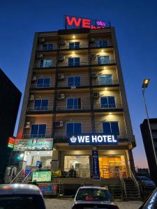 a building with a we hotel sign on top of it at We Hotels Islamabad Airport in Islamabad