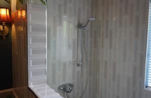 a shower stall with a shower head in a bathroom at Kiltumper Lodge in Kilmihil +19 photos