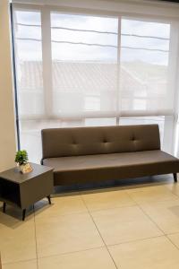 a bench sitting in front of a window at Patio Alto Rooftop in Buga