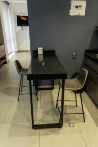 a black table with two chairs in a room at Patio Alto Rooftop in Buga