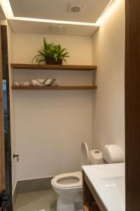 a bathroom with a toilet and a sink at Patio Alto Rooftop in Buga +27 photos