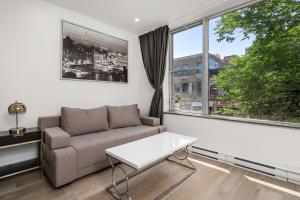 a living room with a couch and a window at Bonjour Plateau Hotel in Montreal