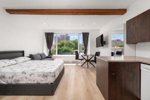 a bedroom with a bed and a kitchen with a table at Bonjour Plateau Hotel in Montreal