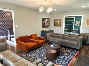 a living room with two couches and a rug at The Legacy House in Topeka