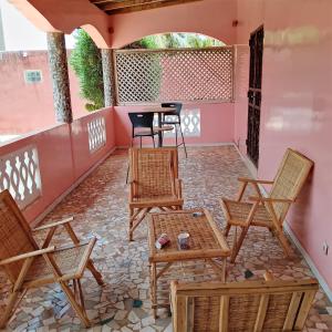 a patio with chairs and tables and a table at Keur Diédhiou in Saly Portudal