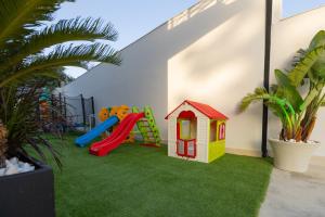 a childrens play area with a slide and a playground at ZANI'S VILLA in Vlorë