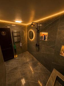 a bathroom with a shower with a large tile floor at Sheki Panorama Garden in Sheki +28 photos